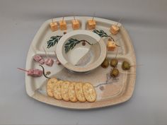 a plate with crackers and olives on it