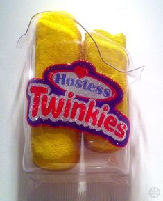 two yellow towels in a plastic package with the words hostess twinkies on it