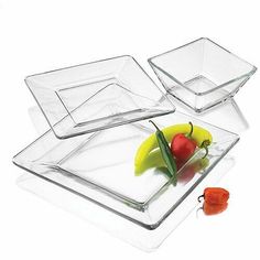 three square glass dishes with peppers and bell peppers on the bottom one has a red pepper in it