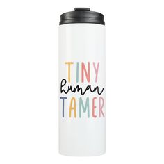 a stainless steel travel mug with tiny human tamer printed on the front and sides