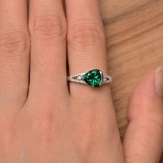 It is a lab emerald ring. The main stone is 8mm*8mm triangle cut, weight about 1.71 carats. The basic metal is sterling silver and plated with rhodium. To change the metal to a solid gold (white/rose) or platinum is also available, please ask for a quotation if you want. You can also go to my shop Home for more elegant rings: https://www.etsy.com/shop/godjewelry?ref=hdr_shop_menu More rings: https://www.etsy.com/shop/godjewelry?ref=l2-shop-header-avatar Customization is always welcome and please Silver Platinum Emerald Gemstone Ring, Silver Emerald Ring Gemstone Gift, Sterling Silver Emerald-cut Emerald Ring For Promise, Silver Pear-shaped Emerald Ring For Gift, Silver Emerald Gemstone Ring For Gift, Elegant Rings, May Birthstone Rings, Silver Engagement Ring, Spinel Ring