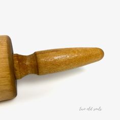 a close up of a wooden object on a white background with the top part of it's handle