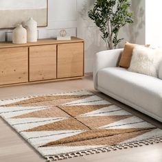 a living room with a white couch and brown rug