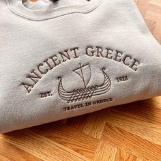 Vintage Greece City Embroidery Sweatshirt, Ancient Greece England Sweatshirt, Greece City Jumper, Vintage Greece Crewneck, Perfect Cosy Jumper for her, Vintage Crewneck Location, Location City Sweatshirt, Vintage City Embroidered Sweater I've included images showing the design on a Beige Sweatshirt, please message me for specific sweatshirt colour requests/a request for changing the embroidery colour. Check out our Shop filled with so many Designs! https://www.etsy.com/uk/shop/TahikoStitch ⬅️⬅️⬅ Vintage Location, Greece City, City Embroidery, Blank Hoodies, City Sweatshirt, Comfy Sweatshirts, Beige Sweatshirt, Oversize Sweatshirt, Cosy Jumper