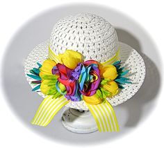 This little girls Easter bonnet is a woven white hat with yellow and white striped grosgrain ribbon that wraps the crown and hangs in tails in back.  A bouquet of rainbow roses and yellow, turquoise and lime accent flowers rest in back. The hat is perfect for Easter or a flower girl in a garden wedding!  This hat measures 20-1/2" at the crown...be sure to measure mid forehead before ordering!  To view my entire collection of Girl's Hats click on this Section.... https://www.etsy.com/your/shops/M Pink Spring Hats With Handmade Flowers, Spring Hats With Multicolor Embroidery, One Size, Girls Easter Bonnet, Whimsical Pink Spring Hat, Yellow Flower-shaped Hats For Spring, Pink Flower-shaped Handmade Hats, Easter Bonnet, Rainbow Roses, White Hat