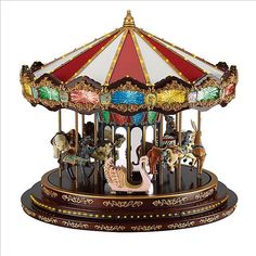 a merry go round carousel with horses on it's sides and a white background