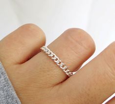 Bold and beautiful. This flexible curb chain ring is handcrafted with high-quality sterling silver material and made to order just for you. Can be worn when washing hands or showering! Wear this chain ring alone or stack it with other rings for a layered looked! Great for gifting. Handmade in Los Angeles, CA! Packaging:  Comes in a gift box, ready for gift-giving! Dimensions: Width: 3mm  Thickness: 0.6mm Material: Sterling Silver / 925 Benefits of Sterling Silver / 925 Jewelry: 1. It's hypoaller Sterling Silver Chain Ring Perfect For Gifts, Silver Chain Link Rings Gift, Sterling Silver Chain Link Ring, Silver Minimalist Chain Link Ring, Silver Chain Link Ring For Everyday, Minimalist Sterling Silver Rings With Chain Detail, Everyday Silver Chain Link Ring, Everyday Silver Rings With Chain Detail, Sterling Silver Chain Ring In White Gold