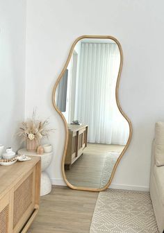 a living room with a couch and a large mirror