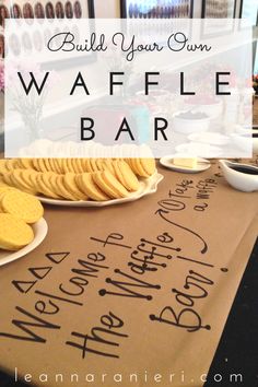 a table topped with cookies and crackers next to a sign that says build your own waffle bar