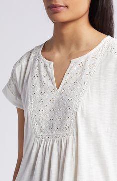 An airy openwork design tops this floaty top perfect for when the weather warms up. 24 1/2" length (size medium) Split neck Short sleeves 60% cotton, 40% modal with 100% cotton contrast Machine wash, tumble dry Imported Relaxed Fit V-neck Pointelle Knit Top, Cotton Broderie Anglaise Tops For Day Out, Spring V-neck Tops With Broderie Anglaise, Breezy Short Sleeve Cotton Blouse, Breezy Cotton Short Sleeve Blouse, Bohemian Pointelle Knit V-neck Top, Bohemian V-neck Pointelle Knit Top, Spring Daywear Blouse With Cutwork Hem, Casual Blouse With Lace Trim And Relaxed Fit