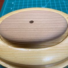 a wooden toy sitting on top of a cutting board