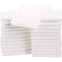 a stack of white towels sitting on top of each other in front of a white background