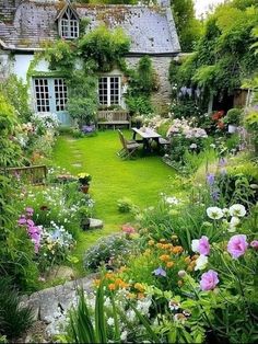 the garden is full of colorful flowers and greenery, with a bench in the middle