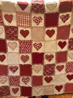 a red and white quilt with hearts on it