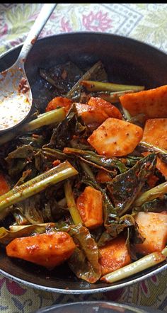 a pan filled with cooked vegetables on top of a table