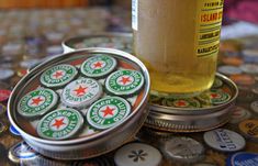 a beer in a tin next to some buttons