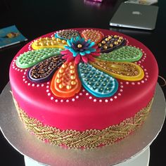 a brightly colored cake sitting on top of a table