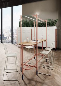 a table with chairs and a plant on it in the middle of an empty room