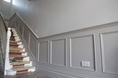 the stairs are lined with carpet and painted in shades of gray, white and beige