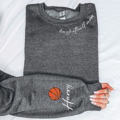 "Custom Basketball Mom Sweatshirt, Basketball Sweatshirt, Custom Sweatshirt, Gift for Mom, Basketball Gift, Custom Gift,Basketball Mom Hoodie Description Due to the nature of the fabric as well as your monitor or mobile screen colors may differ slightly. Our tees and more are handcrafted one at a time. It is therefore very rare to create identical items so you may find minor distinctions that make your SassyPantsTees items special and truly one-of-a-kind. All sales are final. Cancellations, Refu Basketball Mom Sweatshirt, Basketball Shirts For Moms, Basketball Mom Shirt Ideas, Basketball Mom Outfit, Custom Basketball Hoodie, Basketball Tee Shirts, Basketball Mom Shirts, Basketball Hoodie, Basketball Sweatshirts