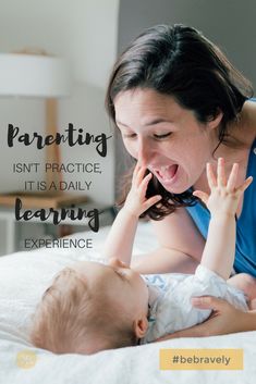 a woman is playing with her baby on the bed