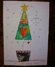 a card with a christmas tree on it and a heart hanging from the top, surrounded by stars