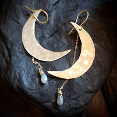 "These signature moondrop earrings feature an iridescent labradorite stone that suspends from a handcrafted, rough cut and hammered, golden brass or antique copper crescent moon. ~14k handcrafted gold fill French hooks & chain ~3\" drop length ~Wrapped in black gift box ~Handmade in Tennessee" Hammered Moonstone Jewelry For Gift, Celestial Teardrop Pierced Jewelry, Hand Forged Teardrop Moonstone Jewelry, Unique Dangle Moonstone Jewelry, Moon Phase Drop Earrings For Jewelry Making, Nickel Free Crescent Moonstone Jewelry, Hand Forged Teardrop Moonstone Earrings, Unique Moon Charm Dangle Jewelry, Hand Forged Moonstone Teardrop Earrings