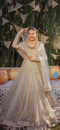 a woman in a wedding dress posing for the camera