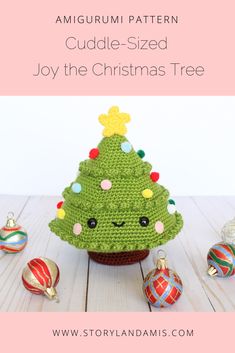 a crocheted christmas tree sitting on top of a wooden table