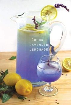 a pitcher of lemonade next to some lemons