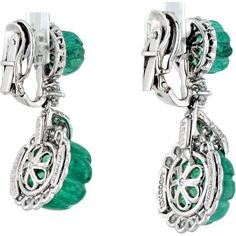 Celebrate the intersection of creativity and class in these exquisite David Webb Platinum Carved Green Emerald And Diamond Drop Earrings. Adorn your ears with the allure of nature's green beauty, embodied in the captivating carved green emeralds that dangle gracefully, accentuated by the brilliance of round-cut diamonds. Each earring is a masterpiece, meticulously crafted in platinum, weighing a luxurious 22.0 grams, ensuring durability and timeless elegance. Designed by the renowned David Webb, these earrings are a testament to his artistic vision and exceptional craftsmanship, making them a coveted addition to any jewelry collection.Indulge in the allure of luxurious green hues and sparkling diamonds, perfect for special occasions or to elevate your everyday style with a touch of sophist Luxury Green Sterling Silver Diamond Earrings, Luxury Green Diamond Earrings In Sterling Silver, Green Sterling Silver Luxury Diamond Earrings, Luxury Green Clip-on Earrings For Formal Occasions, Luxury Green Clip-on Earrings, Luxury Green Pierced Earrings, Green Luxury Pierced Earrings, Luxury Green Clip-on Jewelry, Green Luxury Earrings