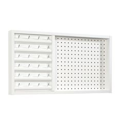 a white wall mounted shelf with holes on the front and bottom, holding several drawers