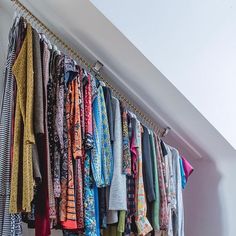 an assortment of clothes hanging on the wall