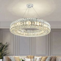 a living room filled with furniture and a large chandelier hanging from the ceiling