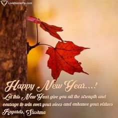 a happy new year card with a red leaf hanging from a tree trunk and the words, let this new year give you all the strength and courage to win