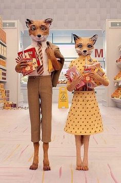 two foxes are standing in a grocery store holding packages and boxes with food on them