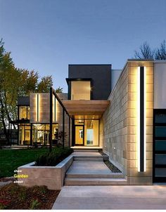 a modern house is lit up at night