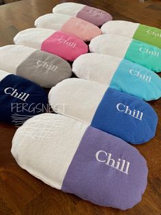 several pillows with different colors and names on them