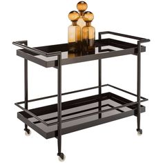 a black serving cart with three bottles on top and two glass vases on the bottom