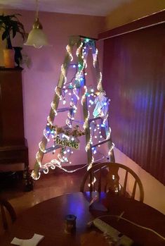 a decorated christmas tree sitting on top of a wooden table