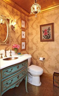 a bathroom with a toilet, sink and mirror in it's center piece is shown