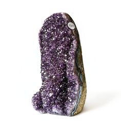 a purple rock with white speckles on it's side and a button in the middle