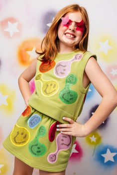 Bring a smile and groovy vibes to your child's wardrobe! Our smocked tank is cute and cropped, complete with a rhinestoned smiley face design. 😃🍉 Pair with the matching skort! Model is wearing a medium Care Instructions: hand wash only, inside out, in cold water