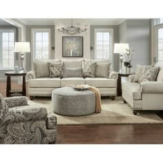 a couch and ottoman in a living room with the caption ever hart sofa shop now