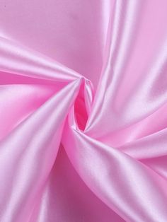 This luxurious satin fabric is perfect for your special occasion designs. Available by the yard, this 58/60 inch wide satin comes in an array of vibrant colors sure to dazzle. The medium weight brings an elegant drape and flow to any garment while maintaining a smooth, lustrous finish. Ideal for wedding and formal gowns, this satin is also suitable for accessories like sashes, headpieces and more. Sew with care as the shiny satin surface can show flaws. Pre-washing is not recommended as it may damage the silky texture. Allow extra fabric for hemming and seam allowances. Enjoy crafting stunning looks with this high quality satin fabric. Luxurious Fabric: This 60" wide satin fabric is lightweight, silky and shiny, perfect for elegant garments or home decor projects. Versatile Material: Mediu Wedding Dress Fashion, Fashion Crafts, Festival Skirts, For Wedding Dress, Elegant Drapes, Stretch Satin, Polyester Satin, Wedding Dress Styles, Pink Candy