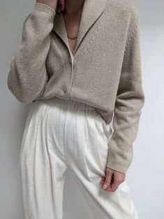 Pale fawn cardigan in a soft knitted cotton. Cardigan has an elegant collar at the neckline, large buttons up the front and a longer drape to the body. Tag reads Victoria Holley Pilling throughout. There is a small discolored mark at the lower front body and incredibly faint discoloration on the sleeves. Collared Cardigan, Long Drapes, Collar Cardigan, Large Buttons, Cotton Cardigan, Small Frame, Final Sale, Sweaters & Cardigans, Vintage Items