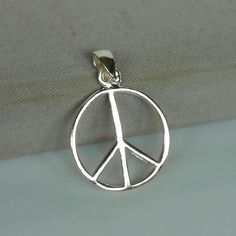 ▪︎ Sterling silver peace symbol charm. ▪︎ Can be used as a charm for necklaces, bracelets, key chains. ▪︎ This pendant is handmade with hypoallergenic sterling silver.Most of my pieces are marked with a 925 silver stamp. ▪︎ Size: 19 x 23 mm Weight: 1.48 gm ▪︎ Please note: This pendant comes without the chain, however, you can add a snake chain in the required length while making your selection. ▪︎ All jewelry arrives in a gift box. We can include a gift message from you if required. ▪︎▪︎ Please Hippie Style Nickel-free Pendant Jewelry, Hippie Nickel-free Silver Necklace, Bohemian Nickel-free Pendant Charm Necklace, Adjustable Sterling Silver Peace Sign Jewelry, Nickel-free Silver Charm Necklaces For Meditation, Yin Yang Bracelet, Yin Yang Charm, Wanderlust Jewelry, Music Jewelry