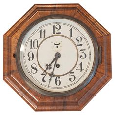 an old wooden clock with roman numerals and numbers on the face, isolated against a white background