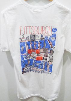 Show off your team pride in this Pittsburgh White Julie Gash Short Sleeve T Shirt! This Pittsburgh Local Stuff Shop Short Sleeve Tee features a screen print graphic. Make sure everyone knows you root for the Pittsburgh with this White Pittsburgh Local Stuff Shop T Shirt. The Steel City! Short sleeve, Crew neck, Relaxed fit, Unisex, Screen printed graphic, 100% Cotton Map Art Illustration, Steel City, Childrens Museum, Print Graphic, Pittsburgh Pa, Short Sleeve T Shirt, Map Art, Shirt White, Art Illustration