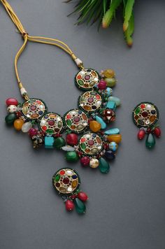 Multicoloured Navrattan Kundan Inspired Necklace with Earrings. This beautifully handcrafted necklace is set in silver and copper alloy and plated with 22k gold. This necklace with a twist of Pearl stones by Paisley Pop is a perfect accessory for an Indian Bride. LENGTH Necklace Size - Length 16 inches Closure - Adjustable Thread Dori DETAILS -100% top Quality Faux Glass Polki -22K gold and silver Plated silver copper alloy. -Handcrafted in our all girls workshop in Paisley Pop Studio, Jammu and Necklace Set Gold, Indian Jewelry Earrings, Kundan Necklace Set, Antique Jewellery Designs, Antique Jewelry Indian, Wedding Jewellery Collection, Indian Jewelry Sets, Kundan Necklace, Inspired Necklace